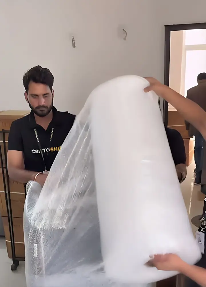 CratoShift crew wrapping furniture in layers before a Gurgaon move